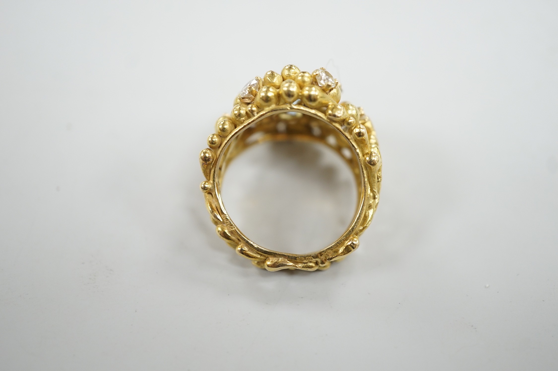 An early 1970's modernist 18ct gold, aquamarine and diamond cluster set dress ring, maker HB or AB? in italics, size O/P, gross weight 16.8 grams.